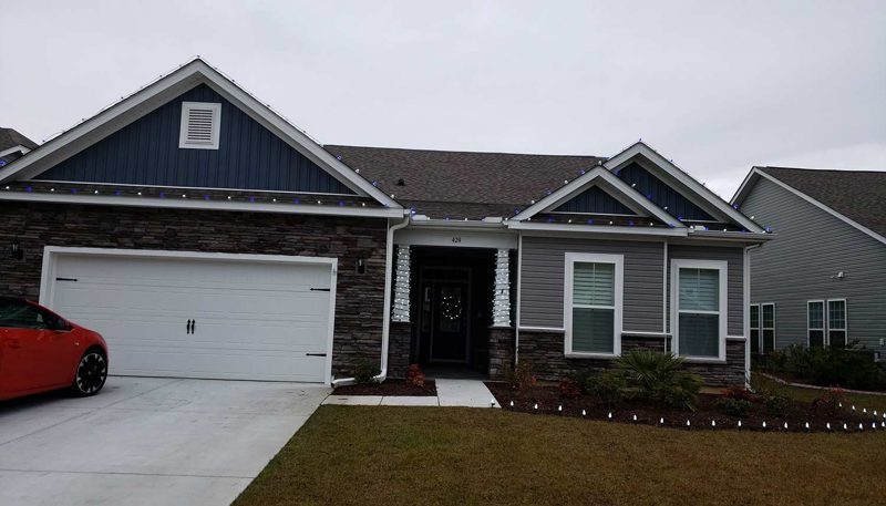 Craftsman-style home with warm white roofline and gable lights
