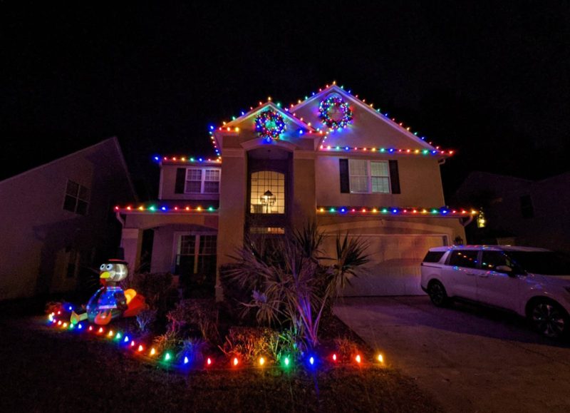Two-story home in Carolina Shores, NC with multicolor roofline lights