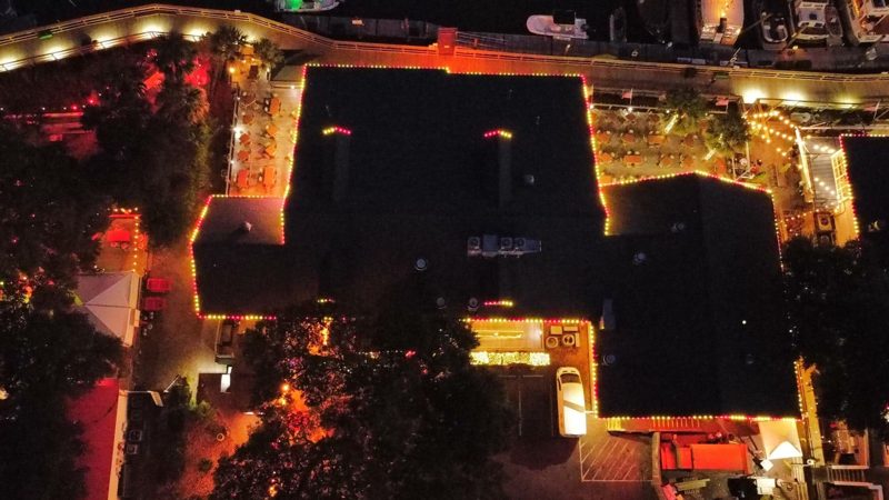 Aerial view of restaurant buildings on the Murrells Inlet MarshWalk lit for Christmas