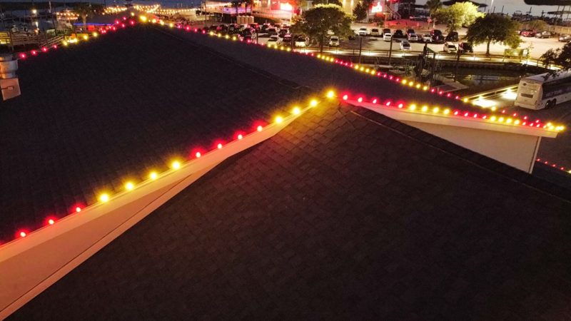 Multicolor C9 LED bulbs along a restaurant roofline