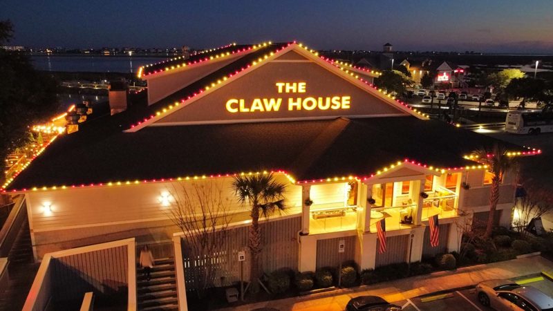 The Claw House restaurant with red, white and warm white roofline lights