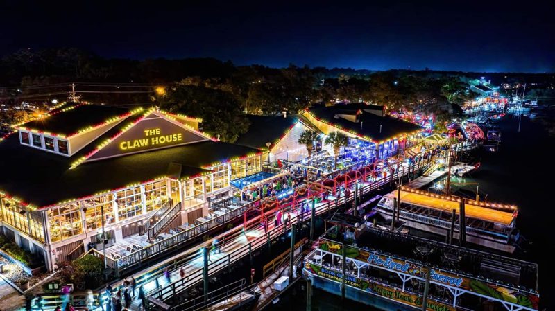 Aerial view of the MarshWalk restaurants lit for Christmas