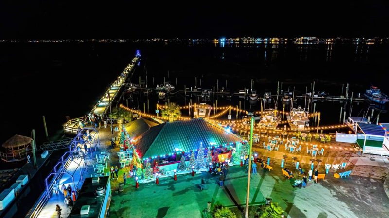 Aerial view of a lit pier and marina at night