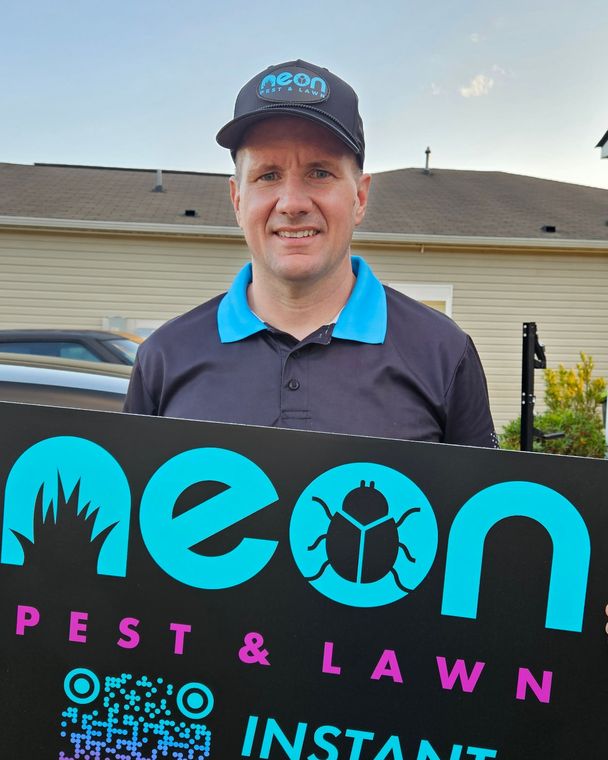Michael, owner, holding the new Neon Holiday Lighting sign